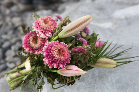 Wedding bouquet. The most important bouquet at the wedding is the bride's bouquet. A bouquet of flowers lies on iceの写真素材