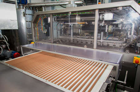 Sweets factory. Sweets production process. Conveyor belt with sweets on it.のeditorial素材
