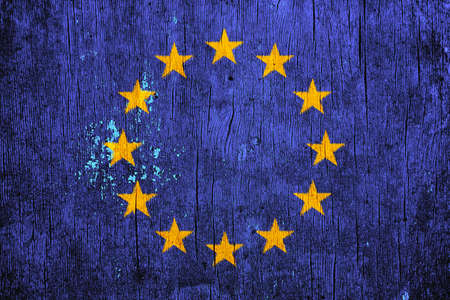 EU flag on texture background. Background for greeting cards for EU public holidays. Europe Day is celebrated on May 9. Day of the Schumann Declaration is celebrated on May 5.の写真素材