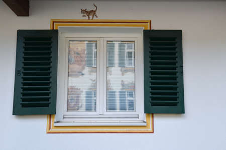 OBERAMMERGAU, GERMANY. View of the beautifully decorated facade of the house with decorative walls...