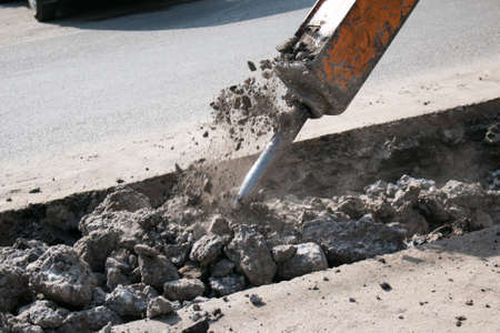 Construction of a new multi-storey building. The work of a jackhammer when laying the foundation.