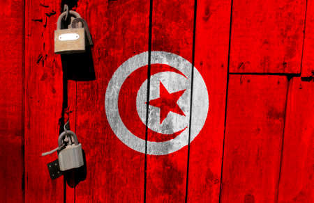 Tunisia flag is on texture. Template. Coronavirus pandemic. Countries may be closed. Locks.
