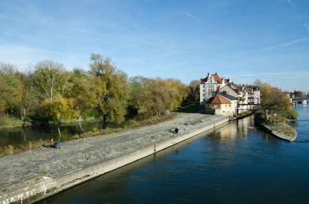 Danube River. Houses on Naberzhnaya. The stone bridge is the main attraction of Regensburg.の写真素材