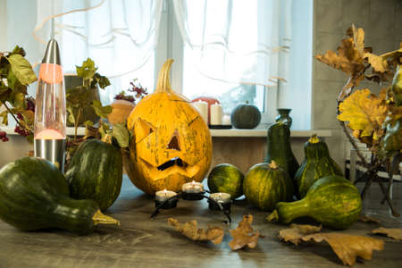 Halloween. Halloween symbol on a wooden table in front of the window. Burning candles in the background.の写真素材