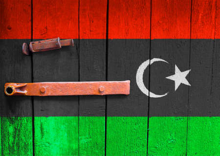 Libya flag is on texture. Template. Coronavirus pandemic. Countries may be closed. Locks.の写真素材