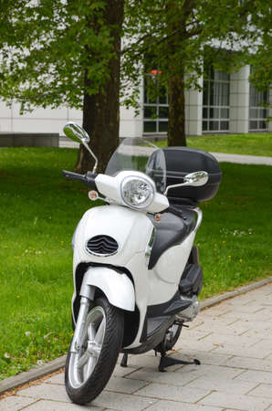 Motorcycle. Parked on the sidewalk near the city building.の写真素材
