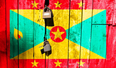 Flag of Grenada is on texture. Template. Coronavirus pandemic. Countries may be closed. Locks.の写真素材
