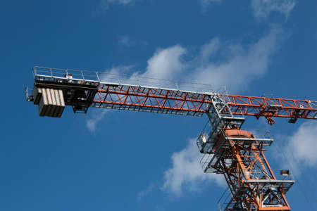 Building. Close-up of a construction crane against the blue sky.