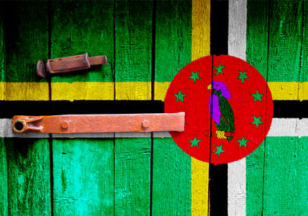 Dominica flag is on texture. Template. Coronavirus pandemic. Countries may be closed. Locks.の写真素材
