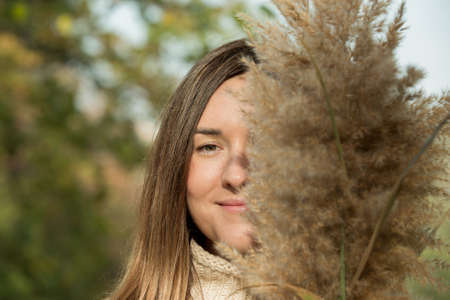 Fall. Portrait of a young beautiful woman with autumn spikelets.の写真素材