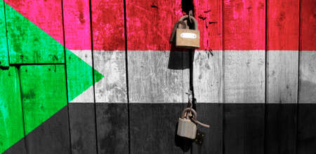 Sudan flag is on texture. Template. Coronavirus pandemic. Countries may be closed. Locks.の写真素材