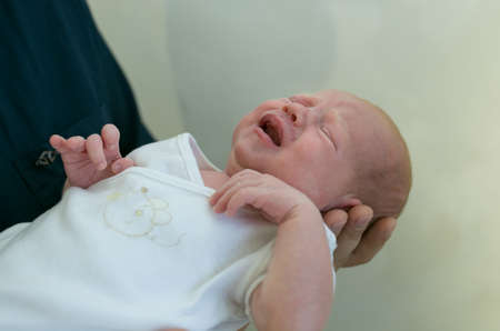 Father holds his newborn daughter in his arms. Emotion concept.の写真素材