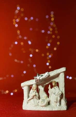 New Year and Christmas card on a red background. Christmas figurine and lights. Content for Christmas.の写真素材