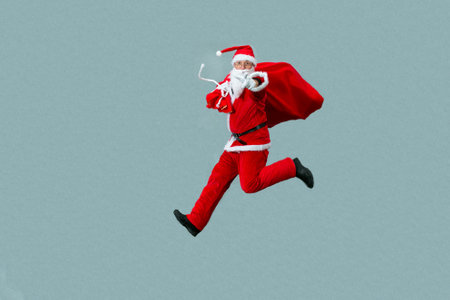 Santa Claus is in a hurry to deliver presents for Christmas. Santa is holding a large bag of gifts.の写真素材