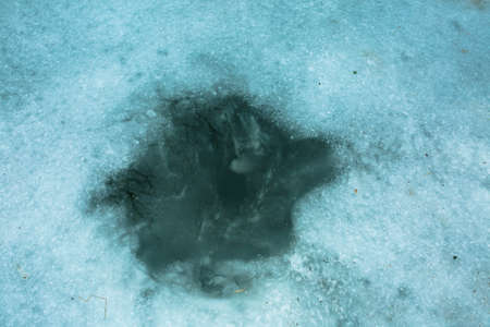 Structure of snow and ice on frozen lake. Winter landscape concept. Frozen river surface view in...