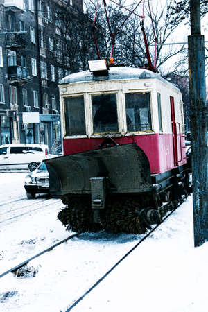 A special tram for cleaning snow on rails. A retro tram removes a layer of snow from the rails with brushes.の写真素材
