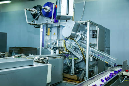 Sweets factory. Sweets production process. Conveyor belt with sweets on it.