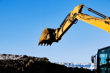 Crawler excavator. The excavator in the process of work digs out the earth and pours it onto the...