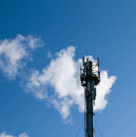 Smoke from chemical factory chimney on cloudy sky background. Ecology theme.の写真素材