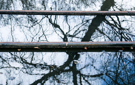 Spring. The snow melts, the water level in rivers and lakes rises. Flooding in the park. The tram rails are flooded with water.の写真素材