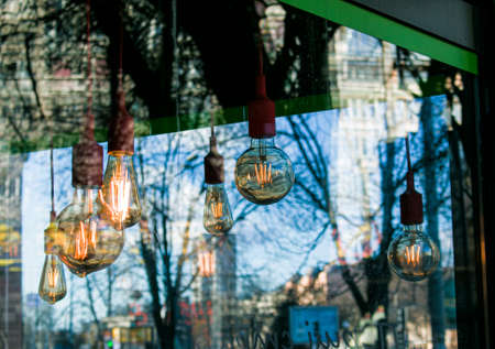 Close-up look-up view of street lighting with light comes on during the daytime. Concept for waste of electricity.の写真素材