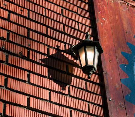 Close-up look-up view of street lighting with light comes on during the daytime. Concept for waste of electricity.の写真素材