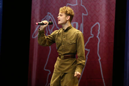 Concert Hall "Cosmos", Moscow, Russia - 11.17.2018: International competition-festival of creative teams "Energy of Creativity" and "Steps of Mastery". The guy is a teenager singing on stage.のeditorial素材