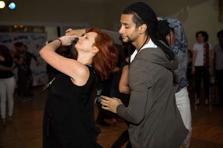 Dnepropetrovsk, Ukraine - 02.25.2017: Dance evening in a city cafe. An Arab man and a white woman are dancing salsa.のeditorial素材