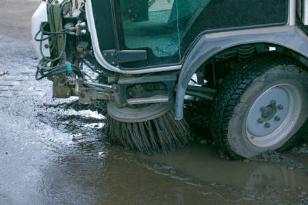 Close-up sweeper machine cleaning. Concept clean streets from debris. Selective focus.の写真素材