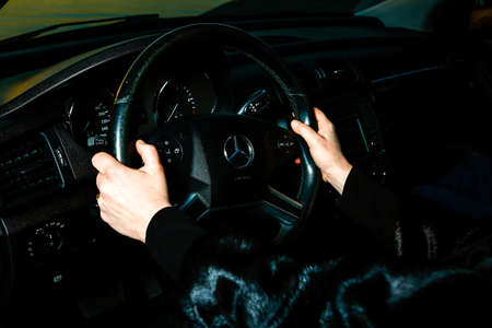 Dnepropetrovsk, Ukraine - 03.15.2021: Car Mercedes-Benz R 350. Woman driving a car. Women's hands...