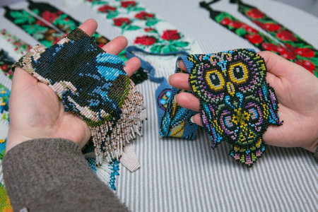 Weaving from beads. Close-up - hands of women with ready-made beads. The woman is fond of weaving...