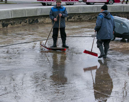 Dnepropetrovsk, Ukraine - 04/08/2021: Cleaning of city fountains in spring before starting work. Workers clean up the dirt that has settled over the season.のeditorial素材