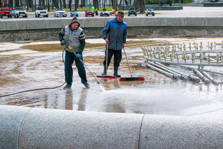 Dnepropetrovsk, Ukraine - 04/08/2021: Cleaning of city fountains in spring before starting work. Workers clean up the dirt that has settled over the season.のeditorial素材
