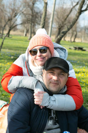 Spring outdoor portrait of a middle aged couple. Man and woman in the spring forest. Fresh air...