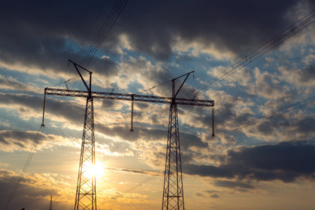 The silhouette of the evening electricity transmission pylon. Power transmission from a power plant...