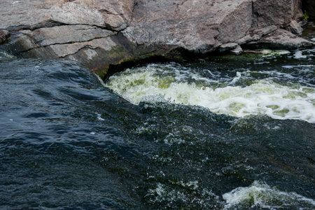 The texture of water on the surface of a small waterfall in the Ukrainian steppe close-up. Tokovsky...