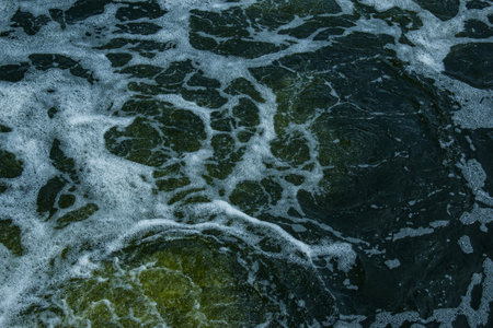 The texture of water on the surface of a small waterfall in the Ukrainian steppe close-up. Tokovsky...