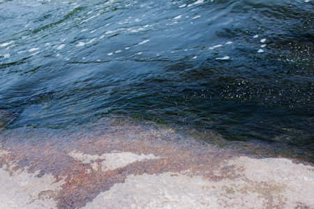 The texture of water on the surface of a small waterfall in the Ukrainian steppe close-up. Tokovsky...