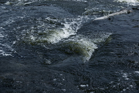 The texture of water on the surface of a small waterfall in the Ukrainian steppe close-up. Tokovsky...