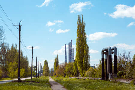 The road leading to the thermal power plant. Chimneys are visible from afar.の写真素材