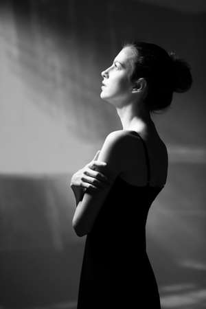 Dnepropetrovsk, Ukraine - 11.28.2016: Black and white portrait of a woman standing in front of a window. Sunlight gives confidence and calmness to the girl's gaze.のeditorial素材