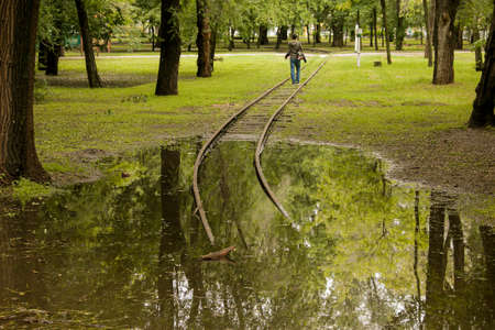 Public park drenched in rain. Water logged park.Wet benches. Park filled with water after rain.Empty park after heavy rain.の写真素材