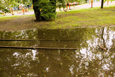 Public park drenched in rain. Water logged park.Wet benches. Park filled with water after rain.Empty park after heavy rain.の写真素材