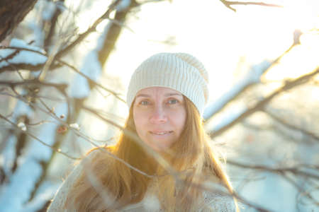Happy woman plays with a snow in sunny winter day. Girl enjoys winter, frosty day. Playing with snow...