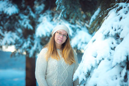 Happy woman plays with a snow in sunny winter day. Girl enjoys winter, frosty day. Playing with snow...