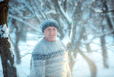 Portrait of a man on a snowy day in the forest. The guy in winter sportswear.の写真素材