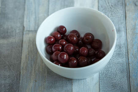 Step-by-step process of making chocolates from dark chocolate and cherries in cognac at home. Cherries in candy brandy are prepared in a plate. Culinary blog concept.の写真素材