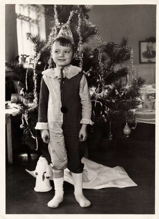 Dnepropetrovsk, USSR - CIRCA 1965: Black and white portrait of a little boy near a New Year tree.の写真素材