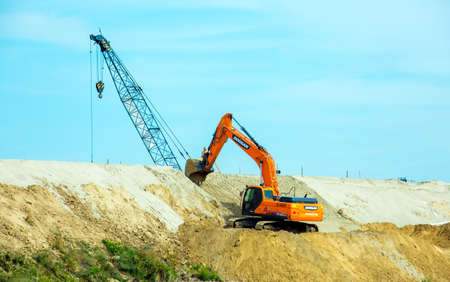 Dnepropetrovsk, Ukraine - 08.17.2021: The excavator works at a construction site in earthworks....