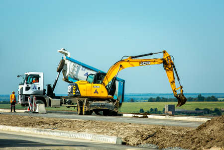Dnepropetrovsk, Ukraine - 08.17.2021: The excavator works at a construction site in earthworks....